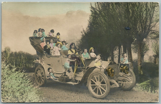 MULTIPLE BABIES DRIVING AUTOMOBILE ANTIQUE POSTCARD