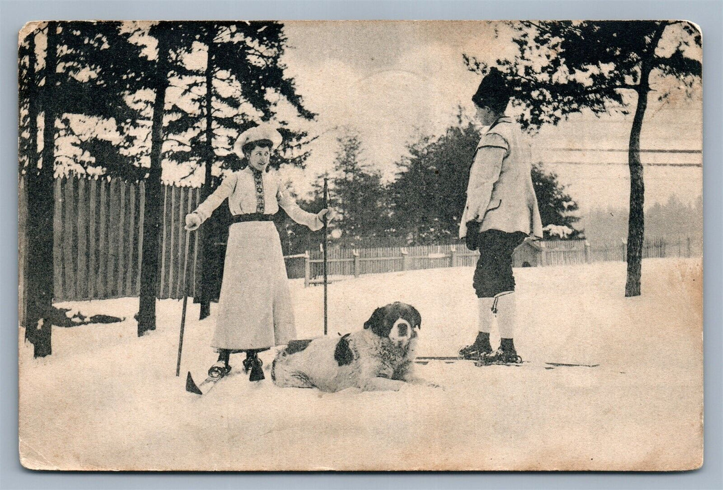 SKIERS w/ DOG ANTIQUE POSTCARD