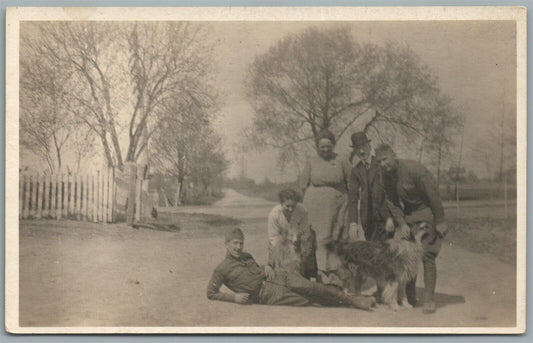 VILLAGE SCENE WITH SOLDIERS & DOGS ANTIQUE REAL PHOTO POSTCARD RPPC