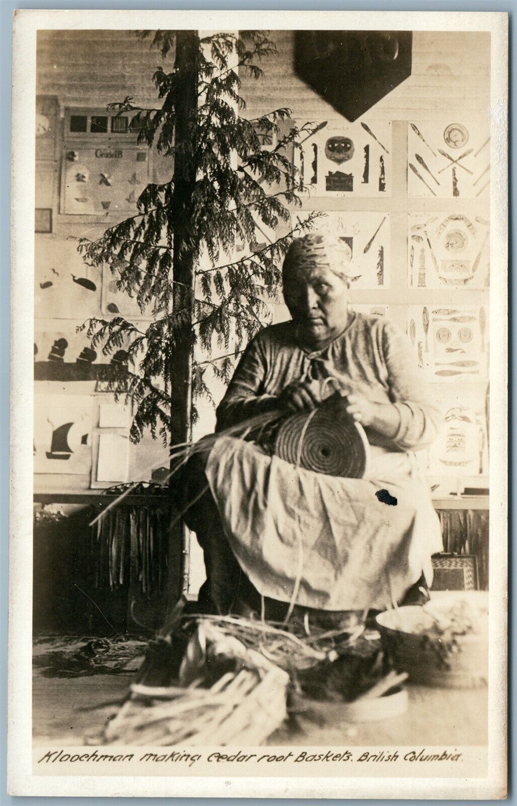 INDIAN KLOOCHMAN MAKING CEDAR ROOT BASKETS B.C. CANADA ANTIQUE REAL PHOTO RPPC