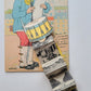 FRENCH COMIC POSTCARD w/ FOLDING MINIATURE VIEWS of VERSAILLES DRUMMER w/ DOG