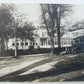 RPPC VINTAGE PHOTO POSTCARD - STREET SCENE w/ OLD CAR