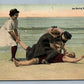 LIFE SAVING ON THE BEACH ANTIQUE POSTCARD