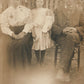 LITTLE GIRL w/ DOLL & PARENTS ANTIQUE REAL PHOTO POSTCARD RPPC