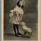 GIRL w/ DOLL STROLLER ANTIQUE POSTCARD