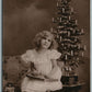 LITTLE GIRL w/ DOLL UNDER CHRISTMAS TREE ANTIQUE REAL PHOTO POSTCARD RPPC