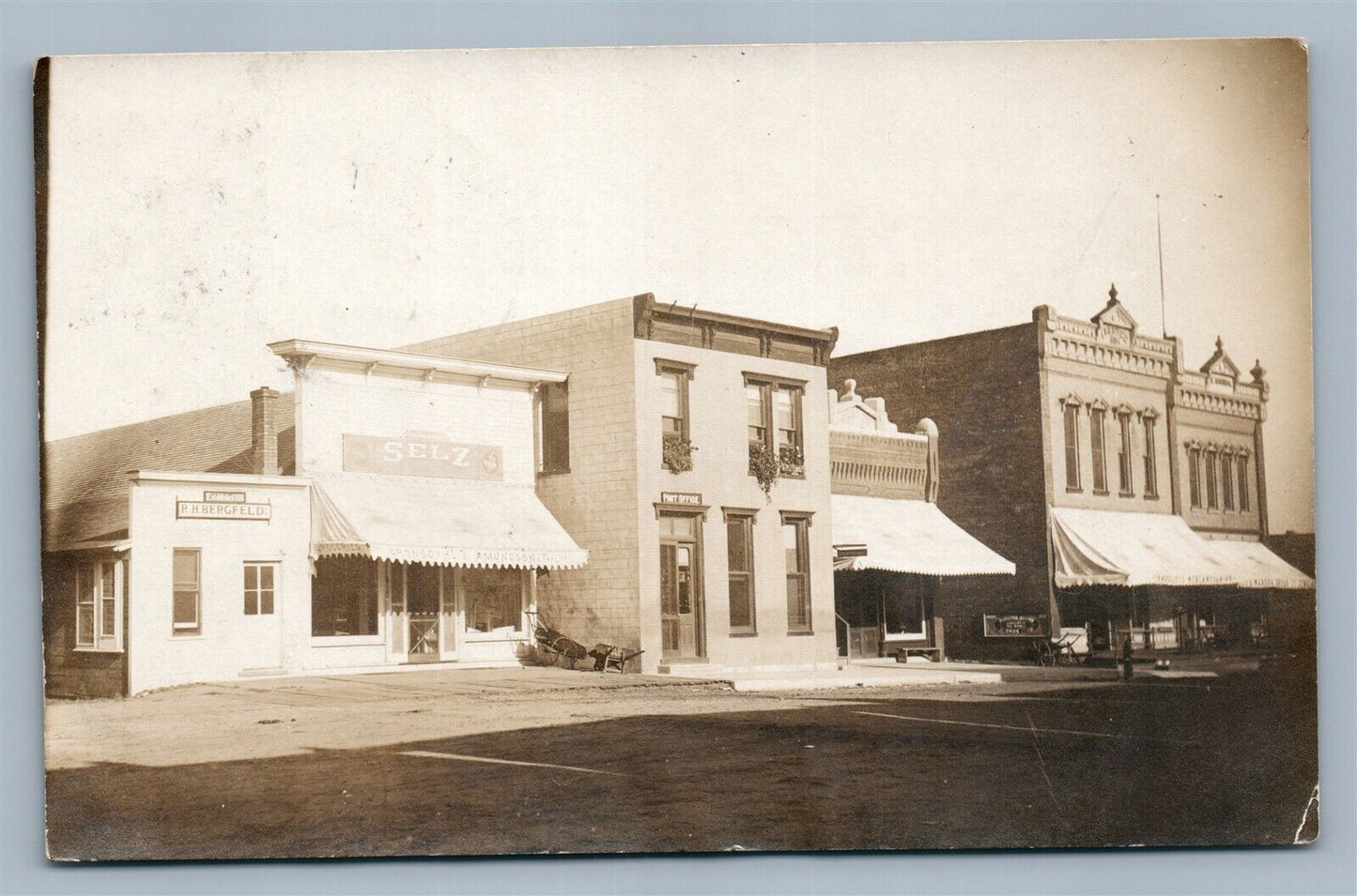 RADCLIFFE IA ANTIQUE REAL PHOTO POSTCARD RPPC STREET SIGNS R.H.BERGFIELD SELZ