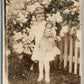 LITTLE GIRL w/ DOLL & FLOWER BUSH ANTIQUE REAL PHOTO POSTCARD RPPC