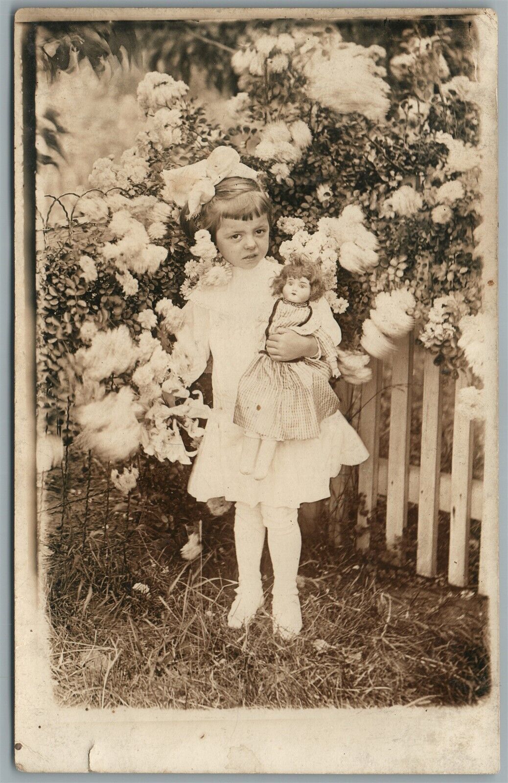 LITTLE GIRL w/ DOLL & FLOWER BUSH ANTIQUE REAL PHOTO POSTCARD RPPC