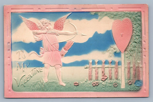 VALENTINE ANTIQUE DEEPLY EMBOSSED POSTCARD CUPID SHOOTING THE HEART TARGET