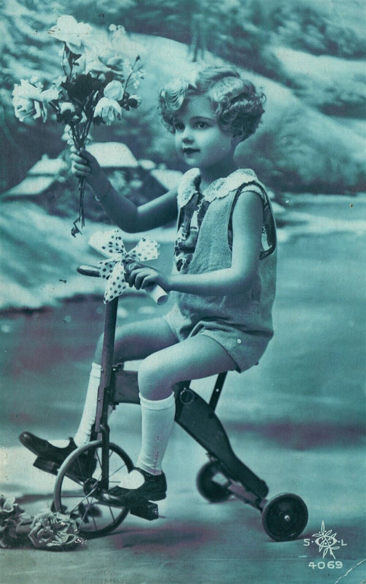 GIRL w/ FLOWERS ON BICYCLE 1934 VINTAGE POSTCARD