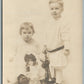 LITTLE GIRL & BOY w/ LARGE DOLL 1912 ANTIQUE REAL PHOTO POSTCARD RPPC